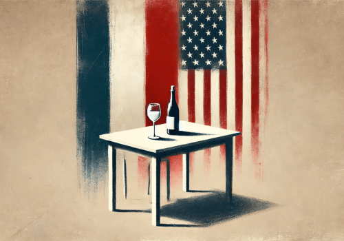 A table with a wine bottle and glass in front of blended French and American flag colors.